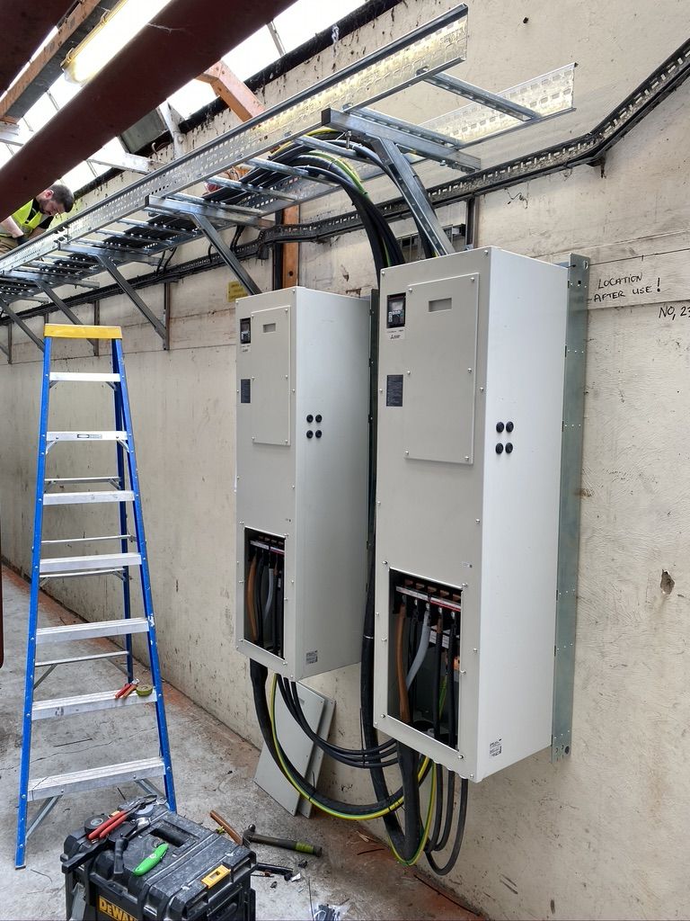 Two drive panels on the wall with big cables