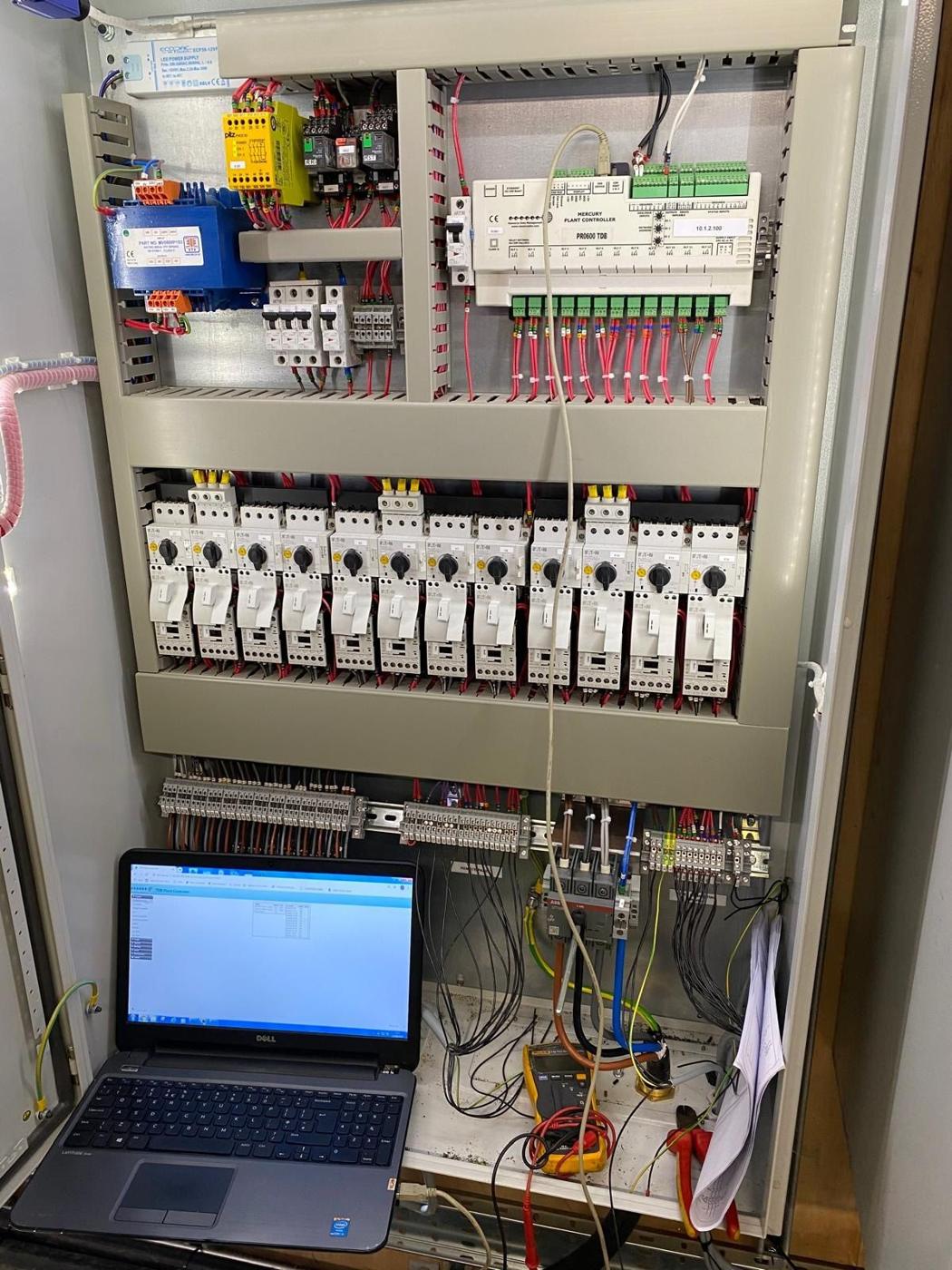 Laptop connected to a control panel during commissioning