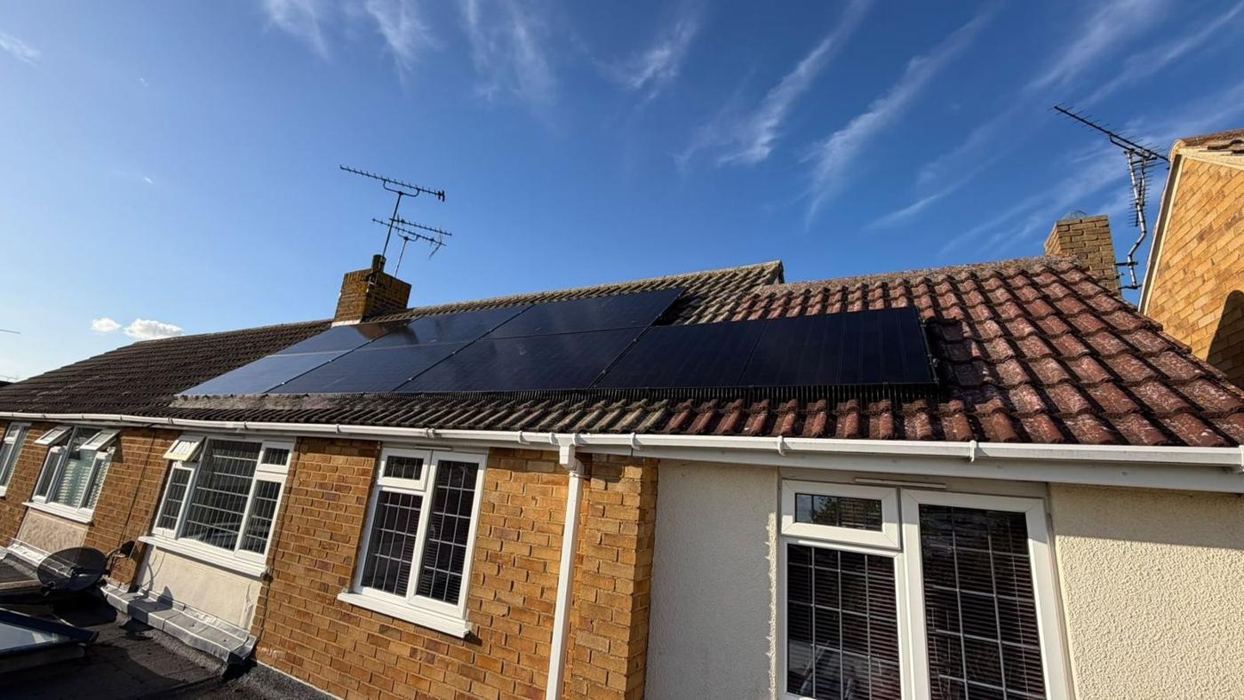 Black panels on a tiled bungalow roof