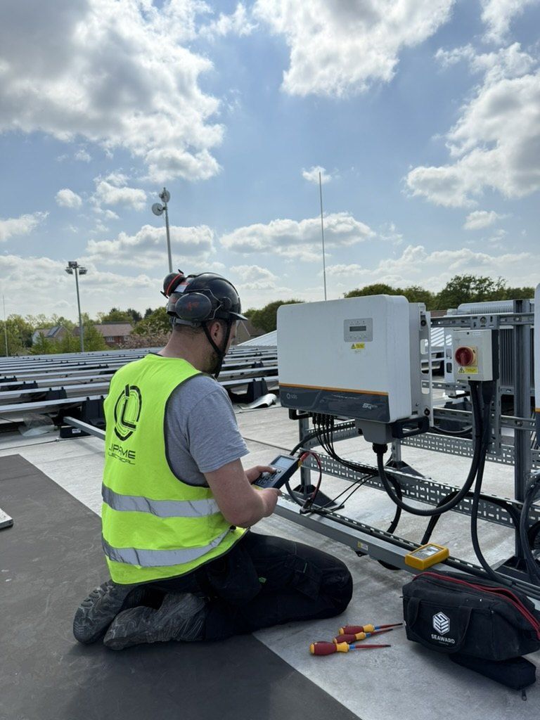 Engineer testing a solar inverter on a roof