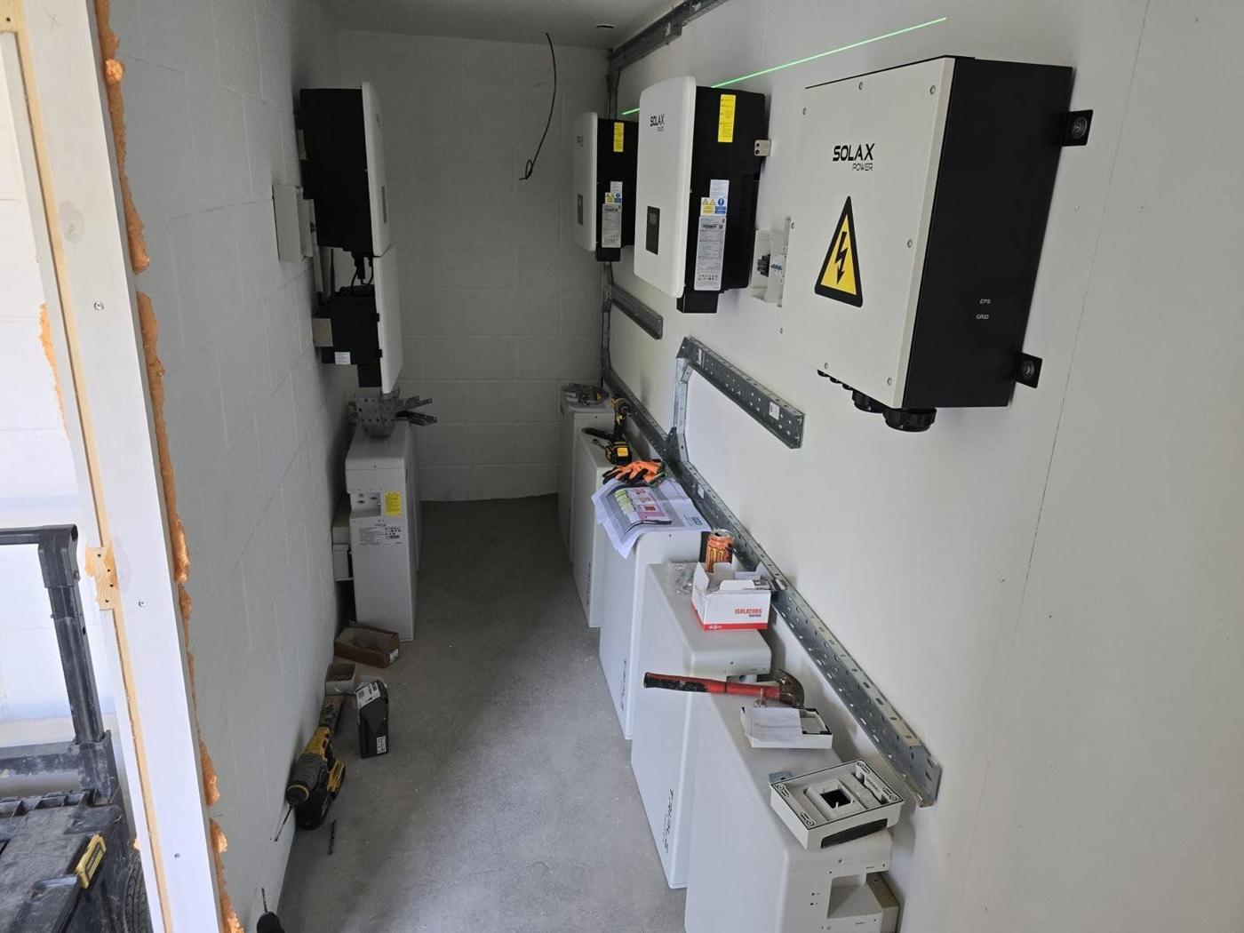 Battery modules and inverter on strut along the wall during wiring