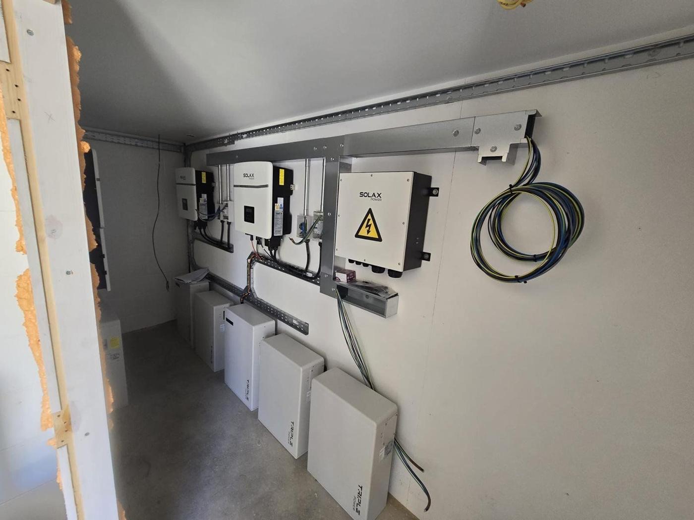 Finished wall of inverters and batteries in the room