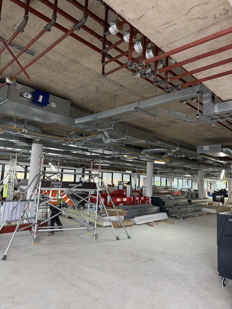 Containment and strut frames across a large open floor