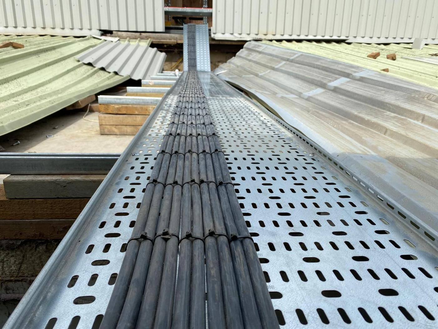 Cables pulled along a roof tray