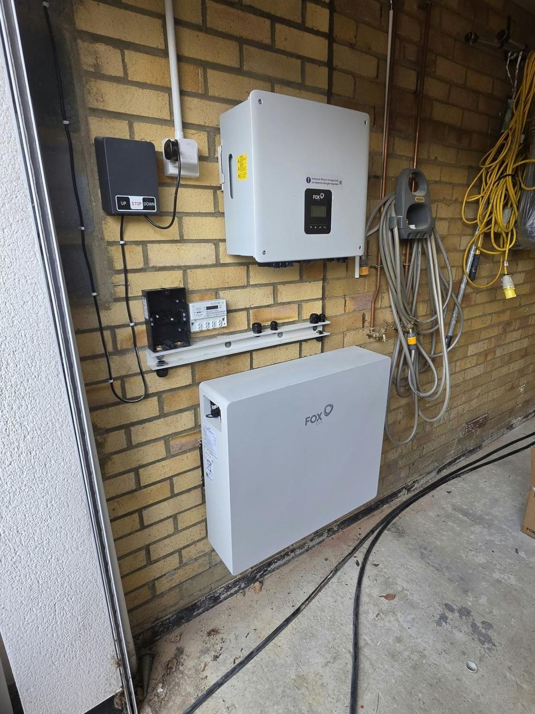 Inverter and battery on a garage wall