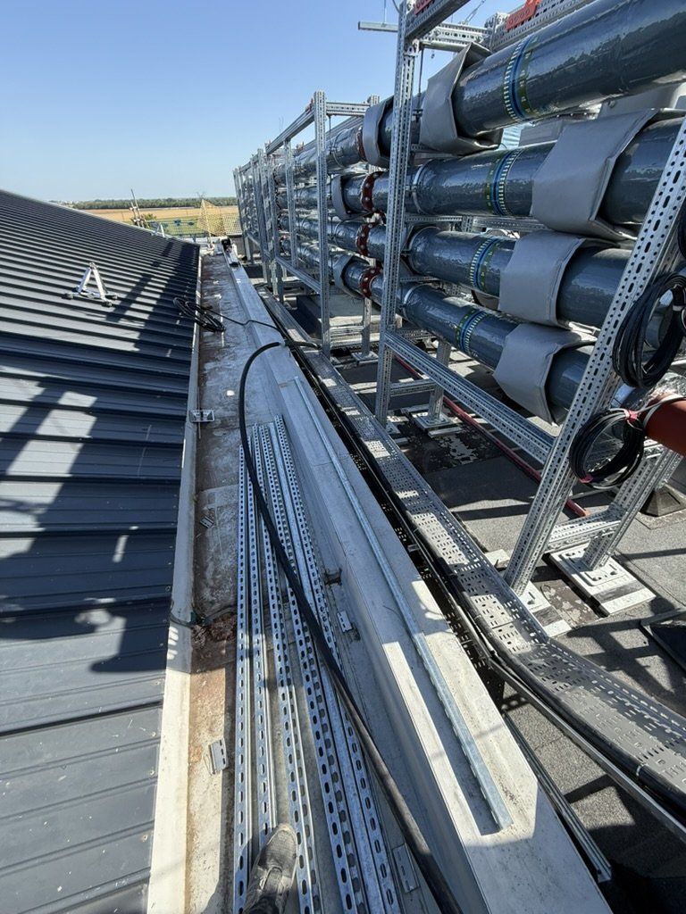 Large cables on roof tray beside plant