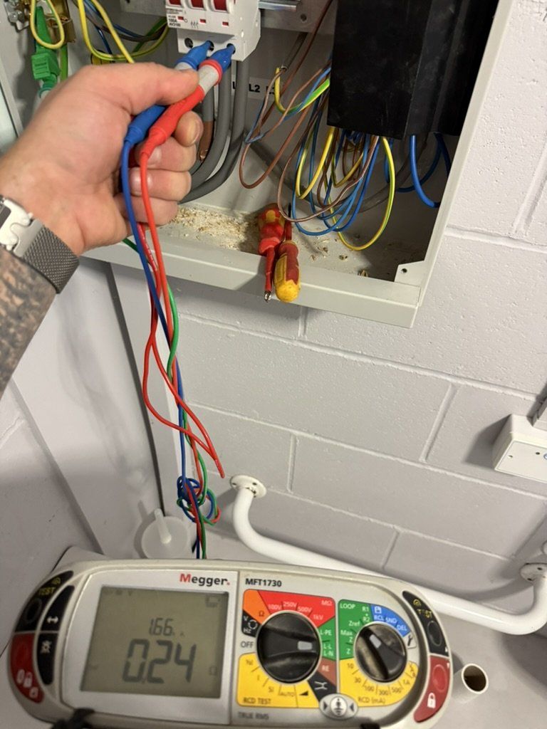 Megger tester with leads connected at a distribution board