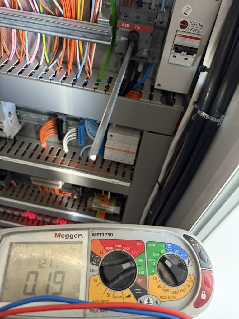 Megger tester below a control panel