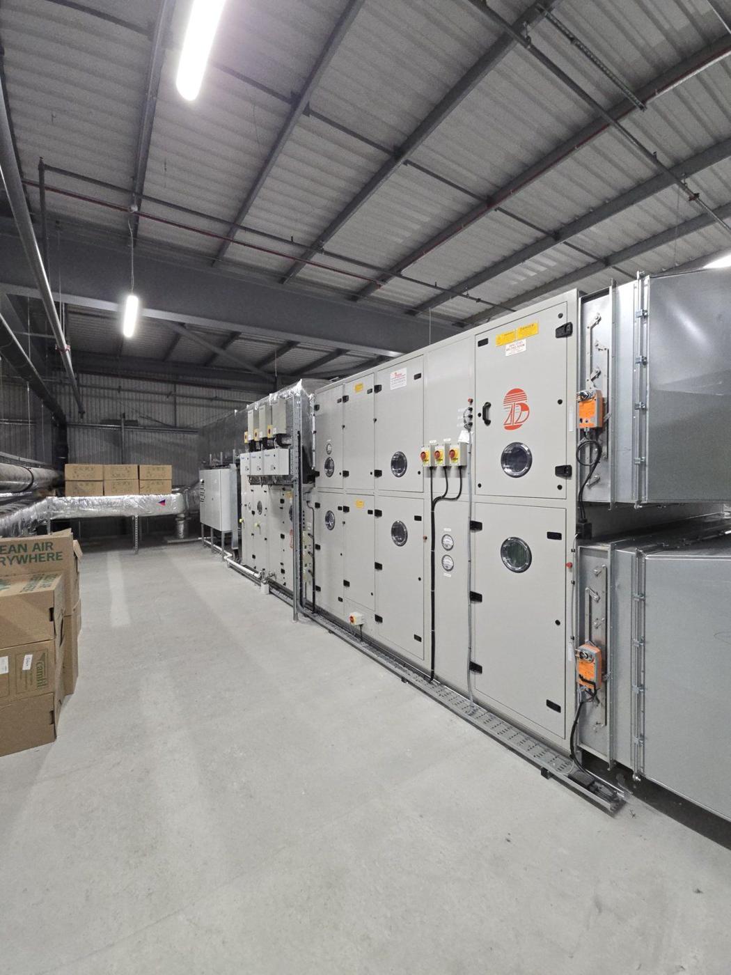 Row of large air handling units in a plant hall