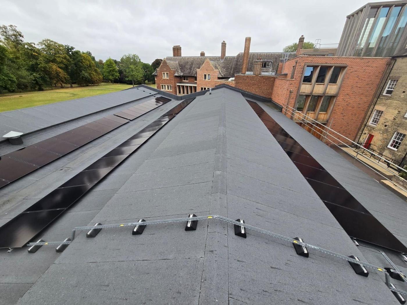 Low, flush array on a roof next to an older brick building