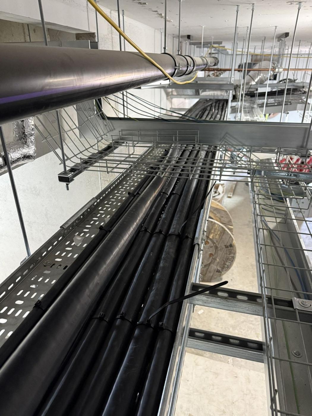 Black cables laid neatly in wide tray