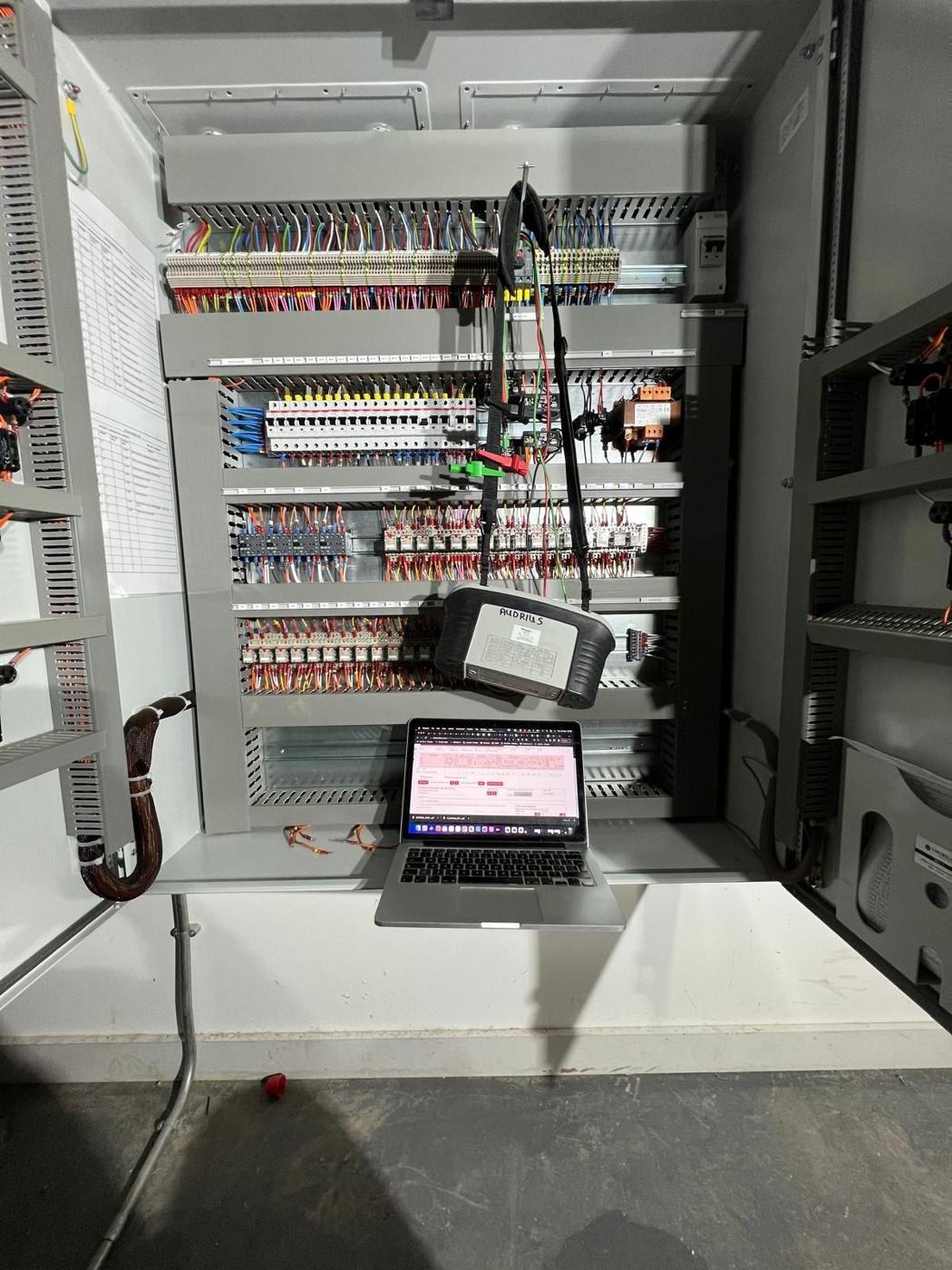 Laptop and test software connected to a new control panel during testing