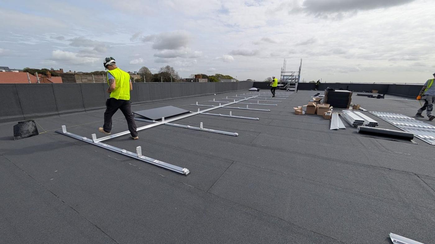Lipame engineers setting out frames on the flat roof