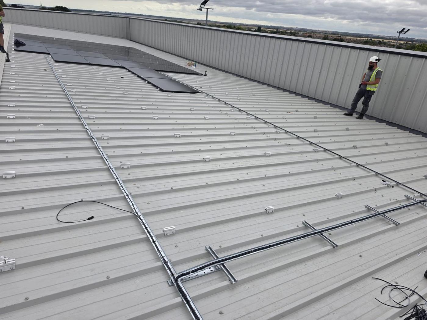 Rails and cable routes set out on the metal roof