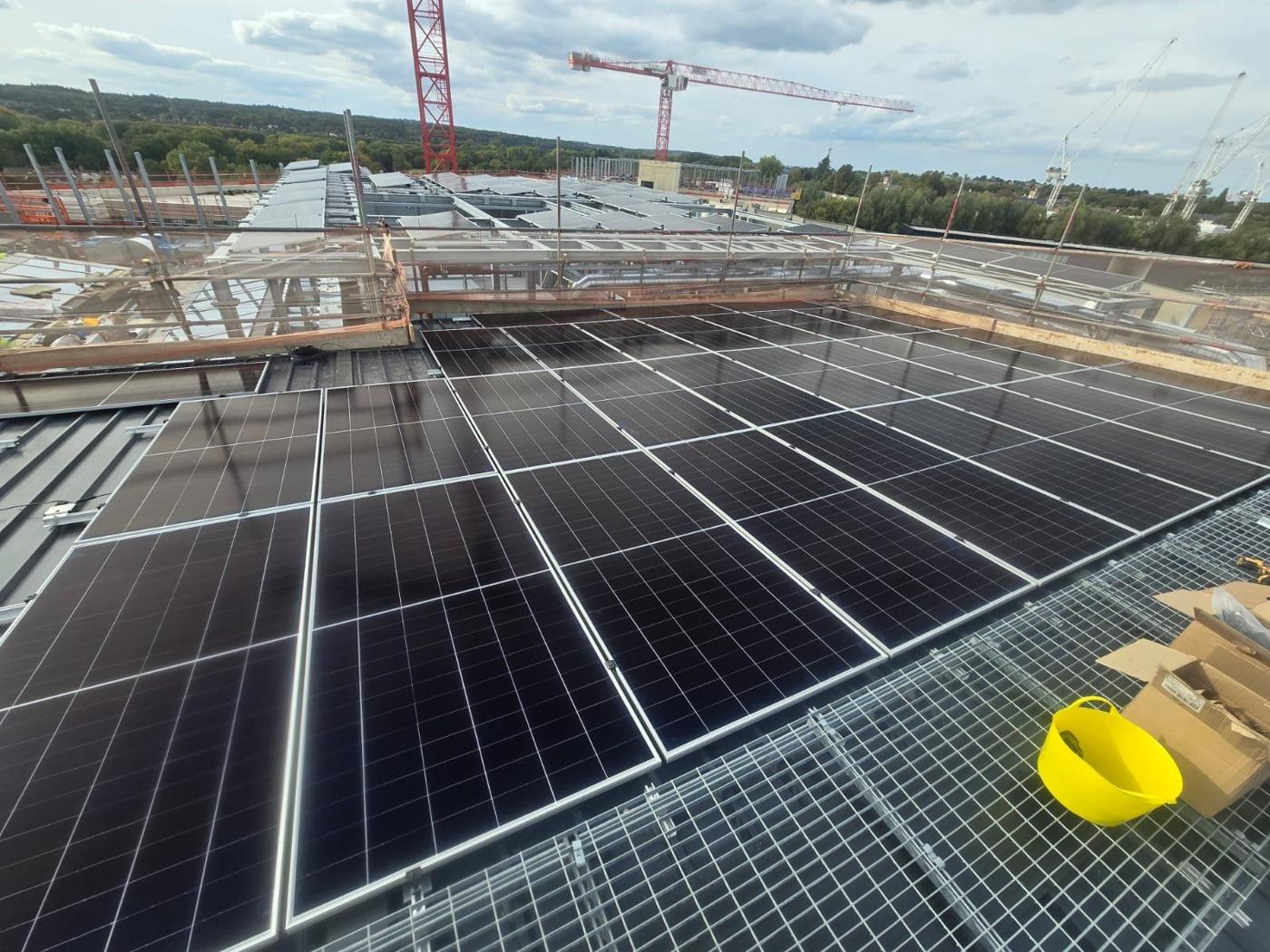 Panels with walkway grating and cranes behind