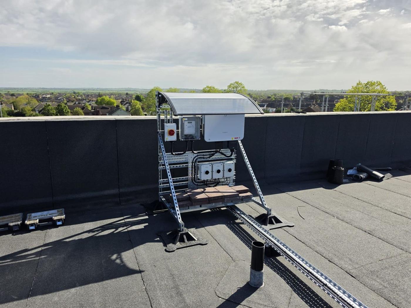 Completed flat roof array with the inverter stand and canopy on the Plume Academy roof
